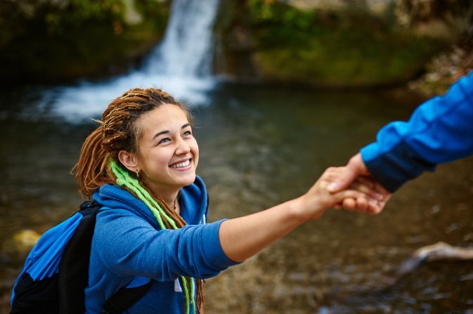 Girl climbing given a helping hand
